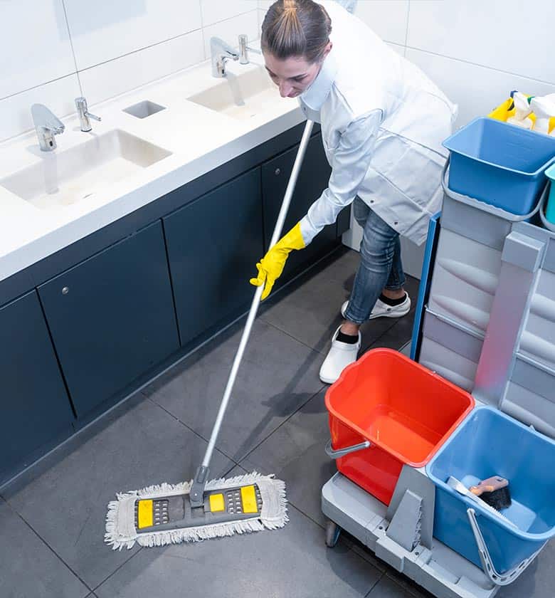 janitor cleaning a bathroom floor