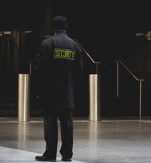 a security guard patrols the outside of an office building